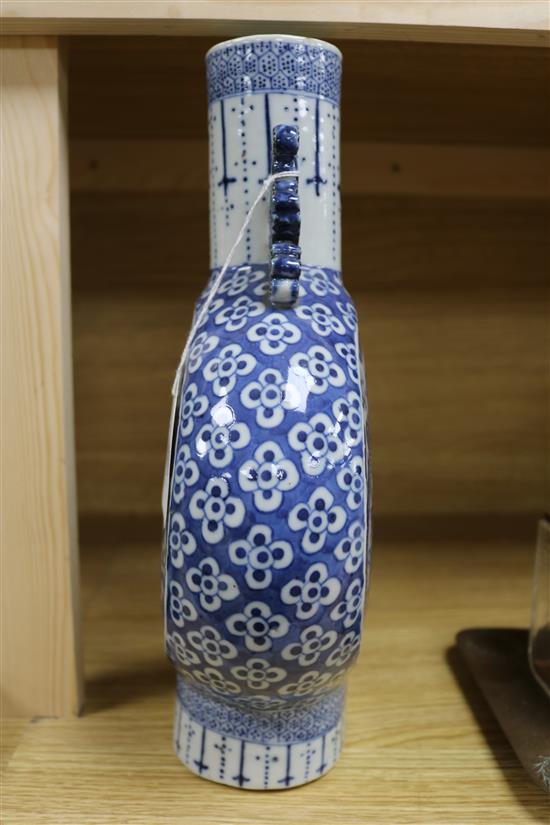 A Chinese blue and white moon flask decorated with dragons